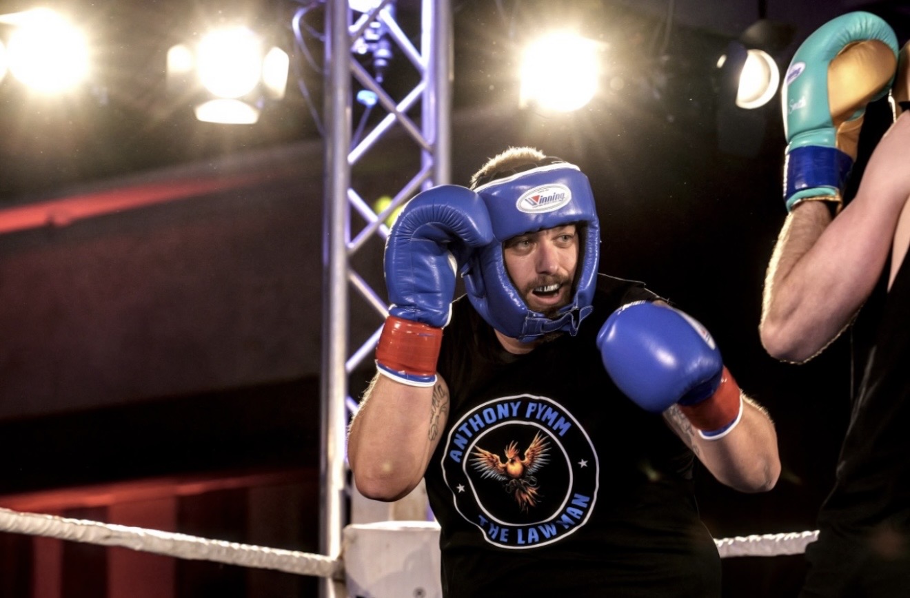 Anthony Pymm boxing in blue protective headgear